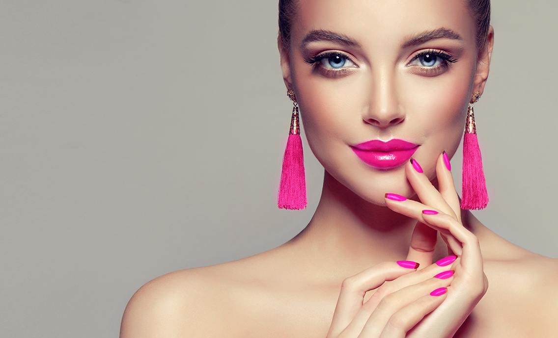BlahFace - The Topic is Beauty - Cosmetic Makeup. Beautiful model girl with pink fuchsia manicure on nails . Fashion makeup and cosmetics . Large earrings tassels jewelry Magenta color