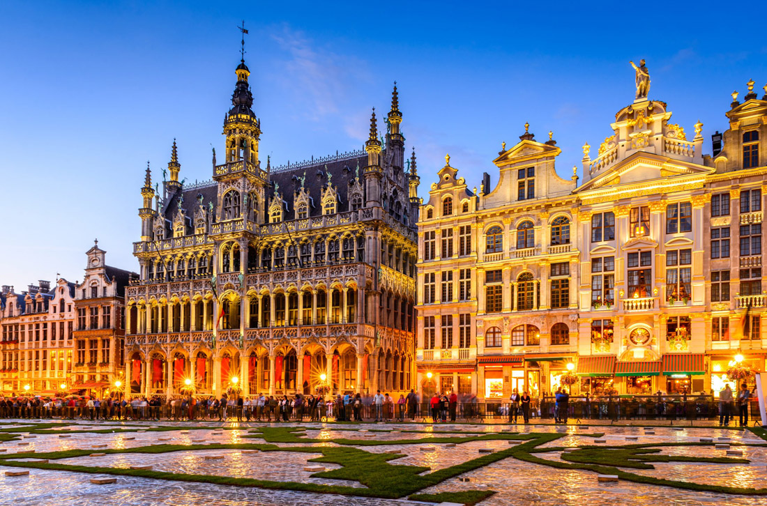 Night scene of Brussels' Grand Place and Maison du Roi, a historic European landmark.