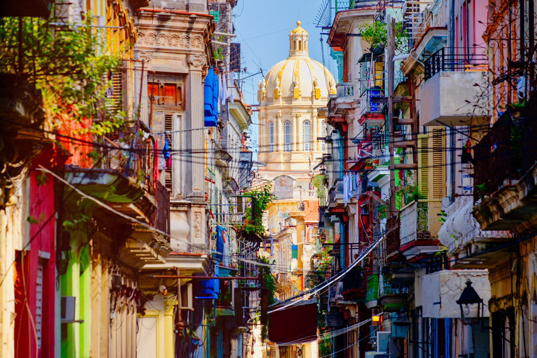 Vibrant street in Old Havana, Cuba, with the Presidential Palace as a captivating backdrop.