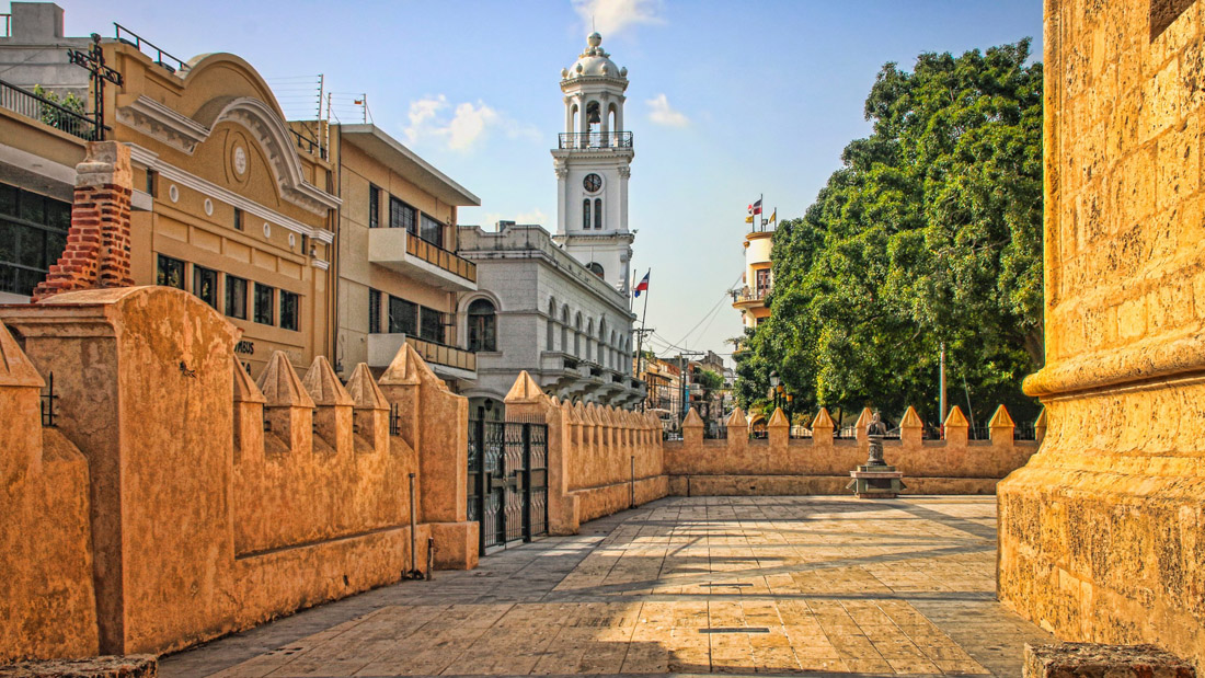 Topic is Travel Destination to Dominican Republic. Historic City Center Plaza with Skyline of Colonial Buildings.