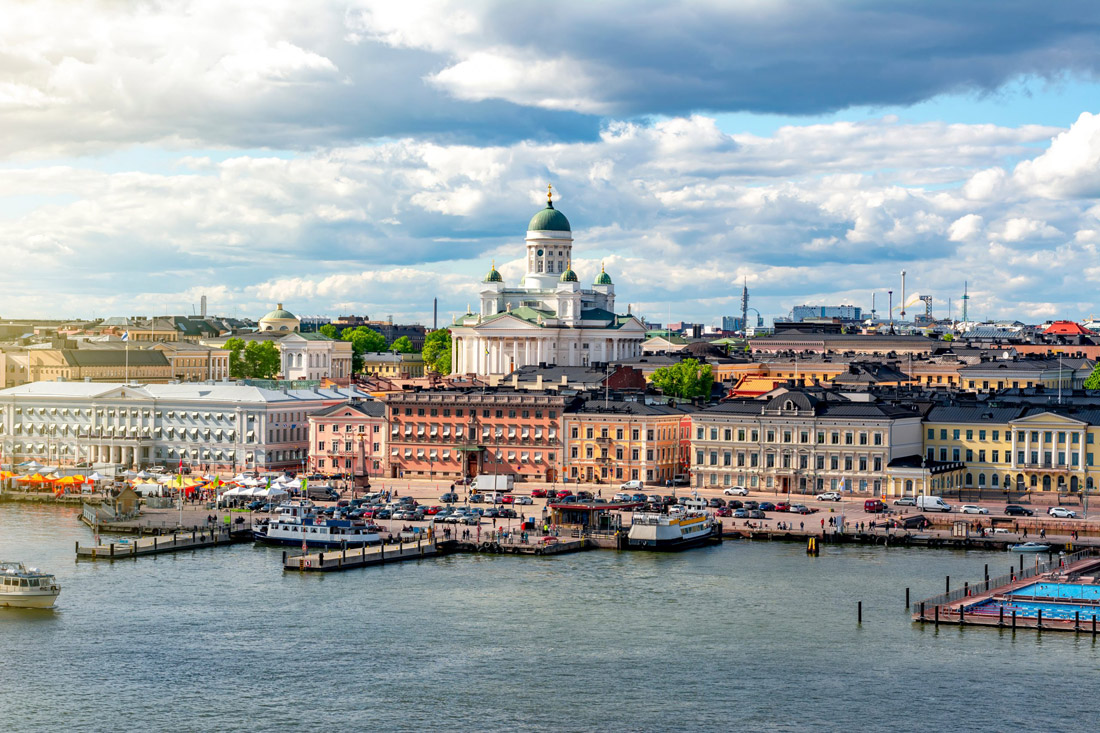 Topic is Travel Destination to Finland. Below blue skies, Helsinki cityscape and Helsinki Cathedral, in Finland.