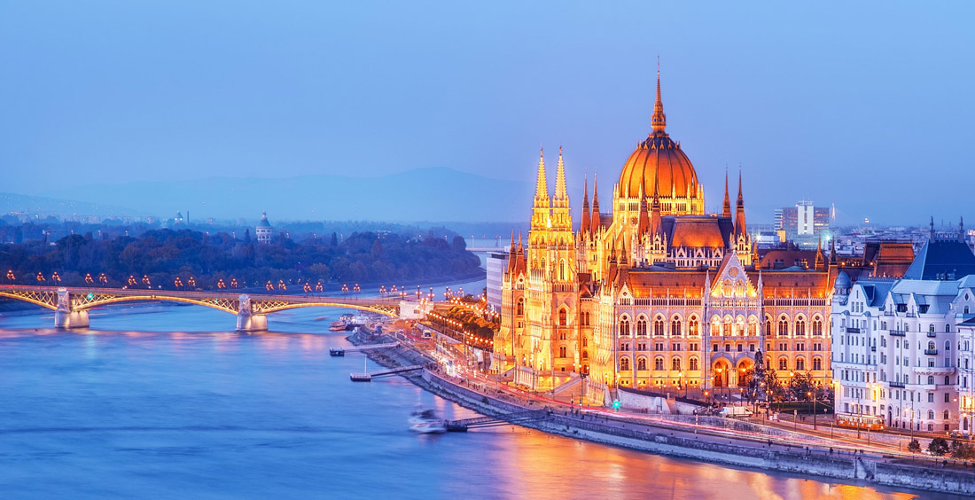 Budapest, Hungary at night: Stunning view of Parliament building overlooking the Danube river delta.