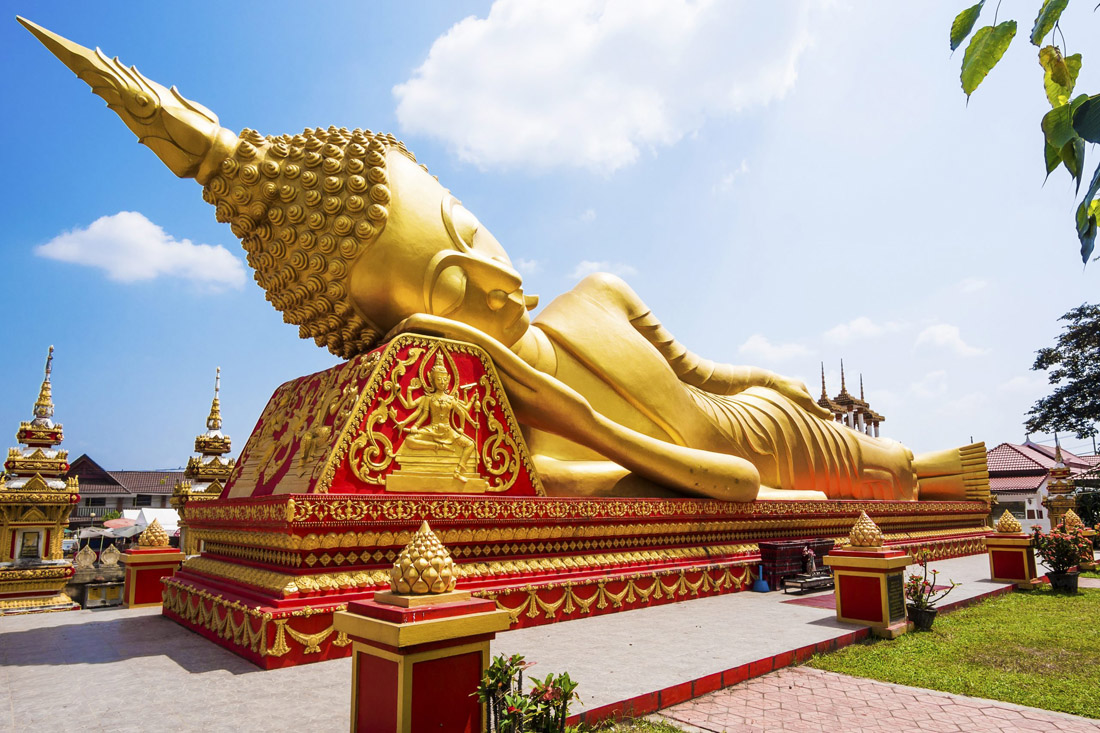 Topic is Travel Destination to Laos. Reclining Buddha statute in Vientiane, Laos.