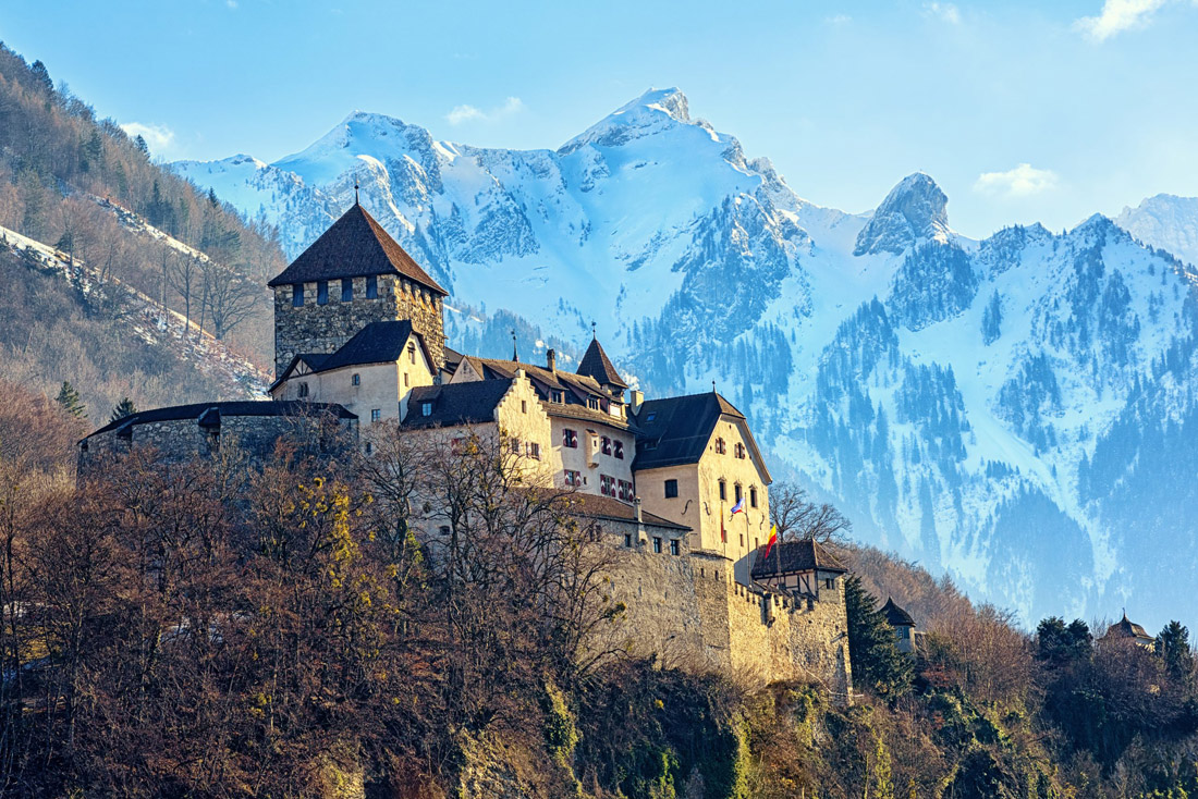 Topic is Travel Destination to Liechtenstein. Winter view with snow covered Alps Mountains and Vaduz Castle, Liechtenstein.