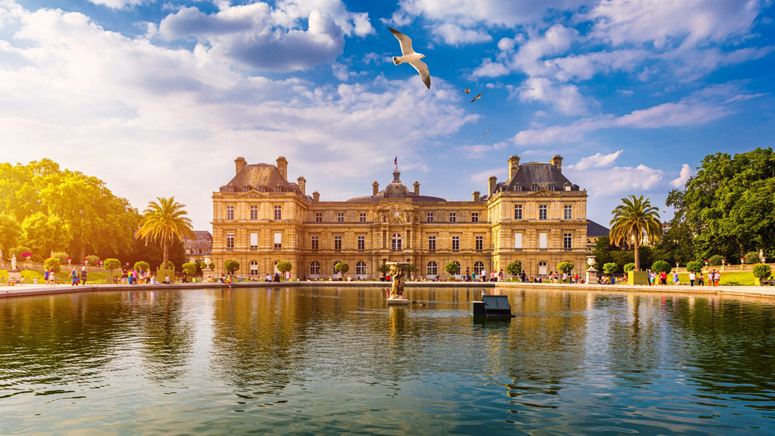 Topic is Travel Destination to Luxembourg. Reflecting on the clear water, the Luxembourg Palace in the Jardin Du Luxembourg