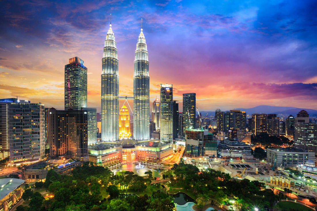 As dusk settles over Kuala Lumpur, Malaysia, the city skyline becomes an awe-inspiring sight, with its iconic skyscrapers, including the Petronas Twin Towers, illuminated against the evening sky. This bustling metropolis presents a captivating blend of modernity and cultural charm, inviting visitors to marvel at its architectural wonders and experience the vibrant energy of Malaysia's capital city.