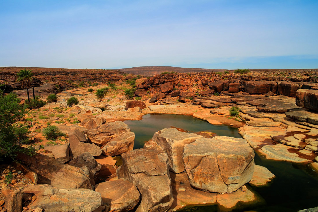 Topic is Travel Destination to Mauritania. Panorama of Rocky Pond on Adrar Plateau, Mauritania.