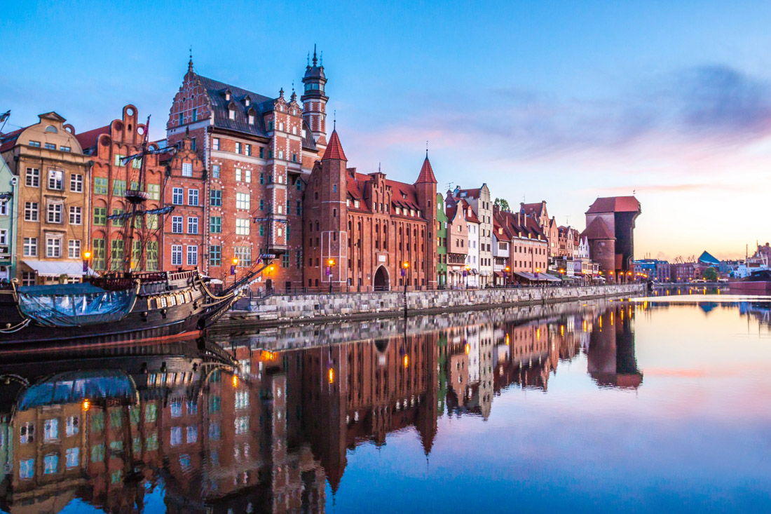 Topic is Travel Destination to Poland. Gdansk Old Town and famous crane at an amazing sunrise.
