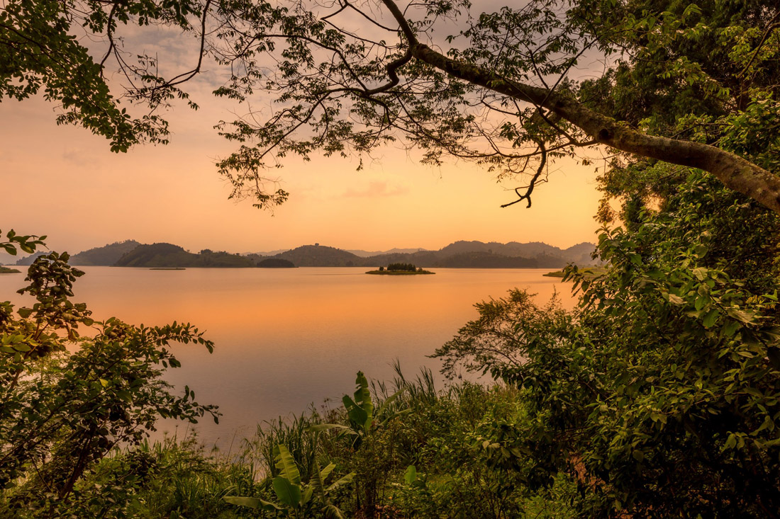 Topic is Travel Destination to Rwanda. Lake Mutanda at Sunset with view of the volcano mountains.