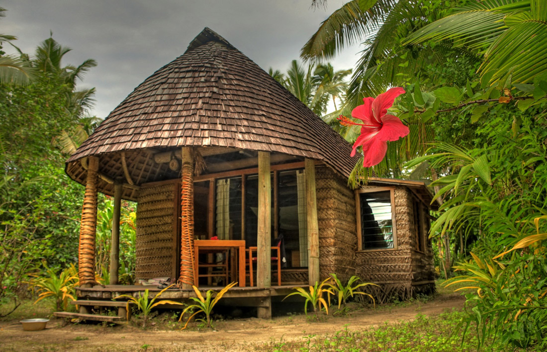 Topic is Travel Destination to Tonga. Photograph of a tropical resort room in Tonga.