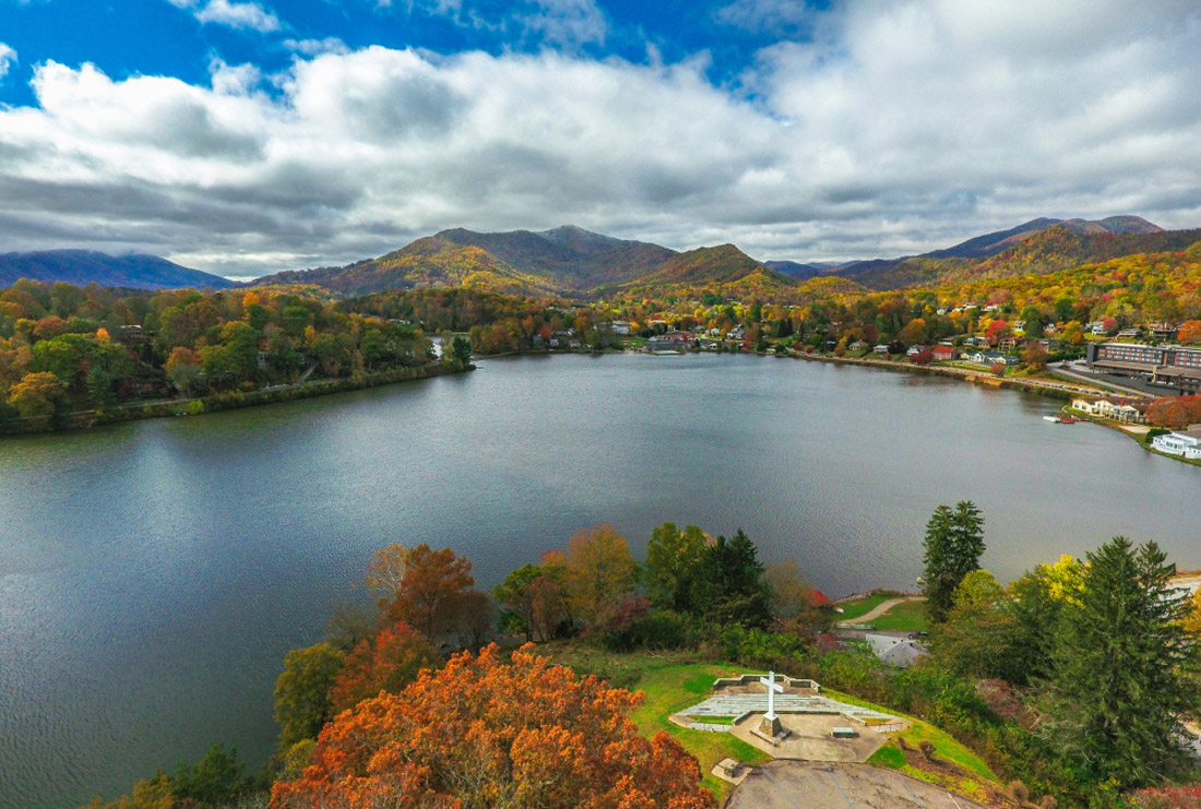 The topic is travel destination to the USA. Drone Aerial of Lake Junaluska near Waynesville and Maggie Valley North Carolina NC during Autumn Fall.