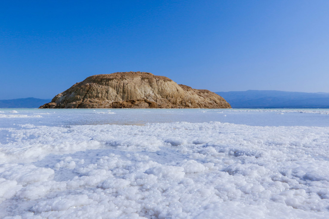 Salty crystalline surface of Lake Assal, Djibouti's captivating natural wonder."