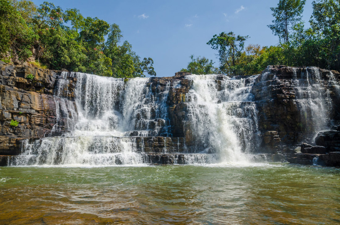 Sala Waterfalls: A stunning cascade surrounded by lush trees and abundant flowing water in Guinea Conakry, West Africa.