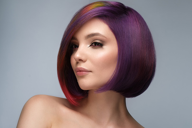 The topic on this page is hair as it pertains to beauty, maintenance, hair styles, hair cuts, hair color, etc. Beautiful woman with multi-colored hair and creative make up and hairstyle. Beauty face.