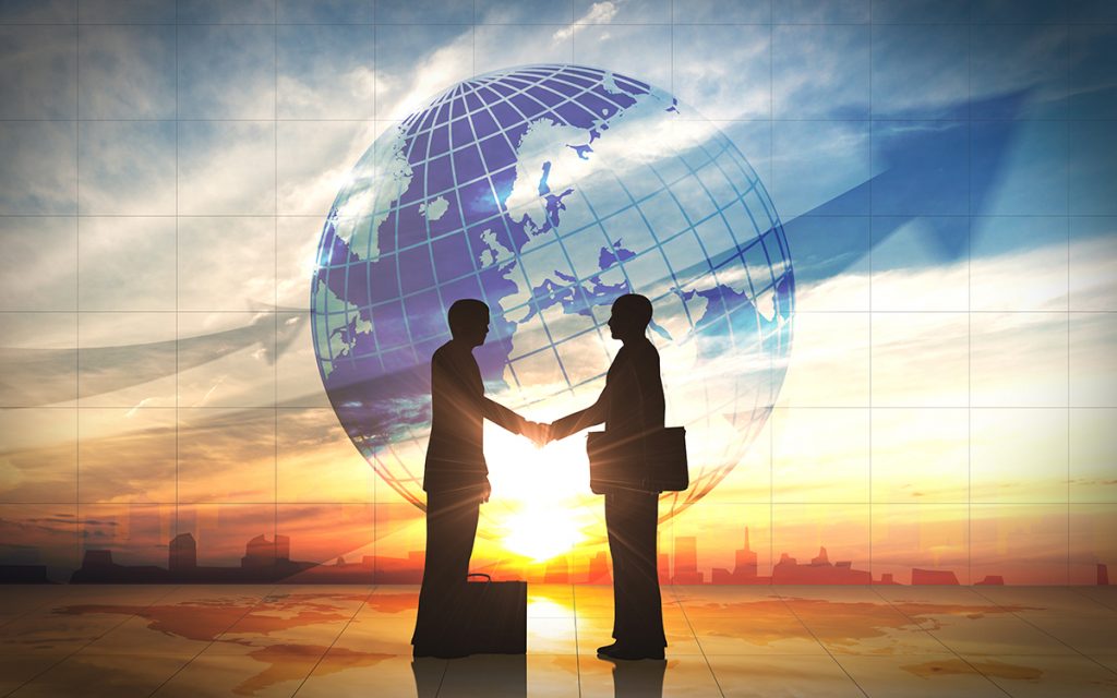 The topic being discussed at BlahFace is Global Trade. Two business man shake hand silhouettes city with global rendered with computer graphic.
